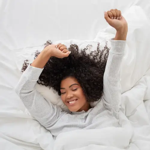 Resident stretching comfortably in fresh linens